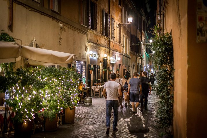 Trastevere street at night with string lights